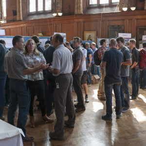 A group of people standing around a table.